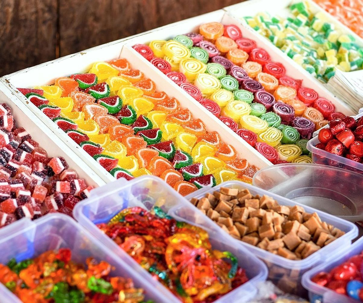 Hands crafting delicate lollipops in our sweet-making studio